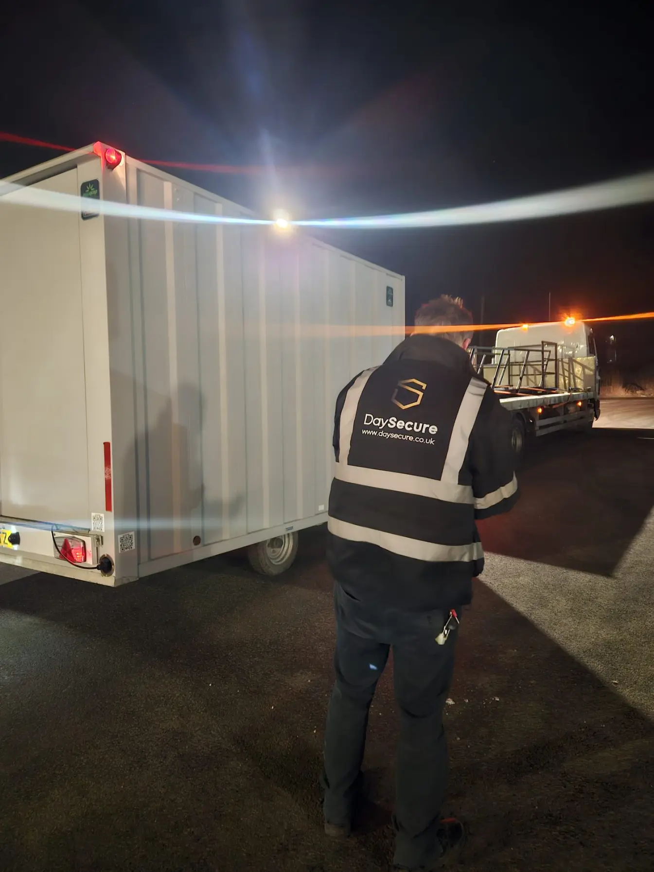 Security Guard checking a vehicle at night